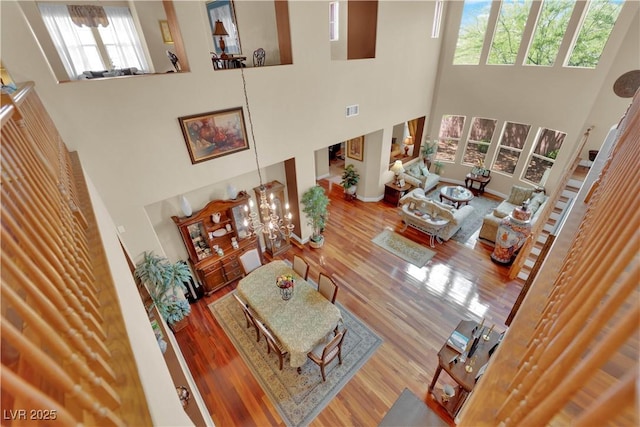 9614 Stonily Ln, Las Vegas, NV 89178 - living room featuring a towering ceiling, wood finished floors, and a chandelier