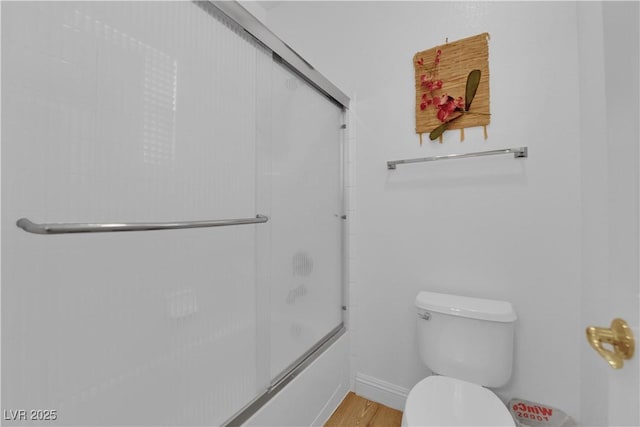 9614 Stonily Ln, Las Vegas, NV 89178 - bathroom featuring toilet, enclosed tub / shower combo, and wood finished floors