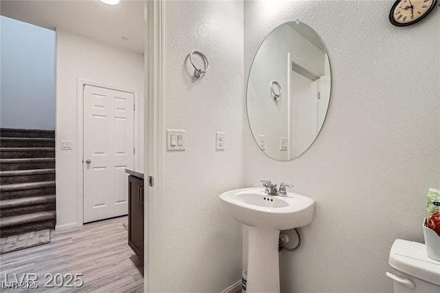 1328 Graphite Ave, Henderson, NV 89002 - half bath with toilet, wood finished floors, and a sink