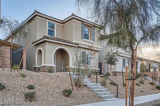 1328 Graphite Ave, Henderson, NV 89002 - view of front of house with stucco siding, a tiled roof, and stone siding