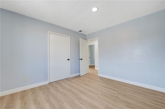 813 E Bartlett Ave, North Las Vegas, NV 89030 - spare room with light wood-type flooring, a textured ceiling, and baseboards