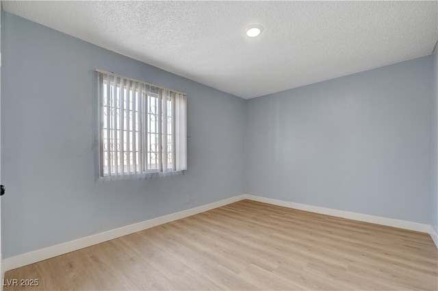 813 E Bartlett Ave, North Las Vegas, NV 89030 - empty room with wood finished floors, a textured ceiling, baseboards, and recessed lighting