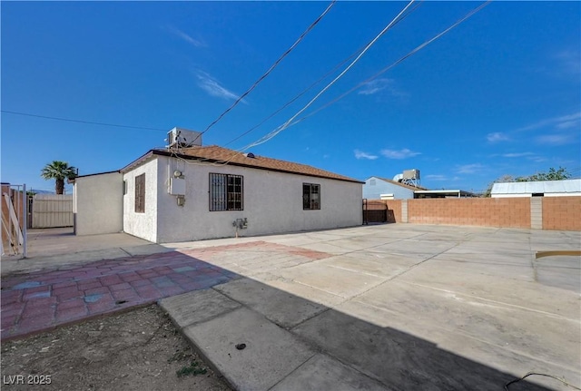 813 E Bartlett Ave, North Las Vegas, NV 89030 - rear view of property featuring stucco siding, a fenced backyard, and a patio area