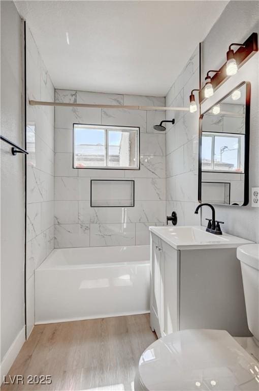 813 E Bartlett Ave, North Las Vegas, NV 89030 - full bath with vanity, wood finished floors, and washtub / shower combination