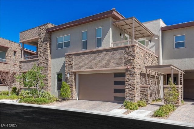 11280 Granite Ridge Dr Unit 1009, Las Vegas, NV 89135 - view of front of home featuring stucco siding, a garage, stone siding, and a balcony