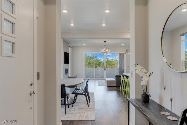 11280 Granite Ridge Dr Unit 1009, Las Vegas, NV 89135 - hall featuring healthy amount of natural light, wood finished floors, a chandelier, and recessed lighting