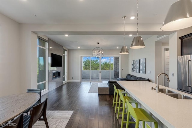 11280 Granite Ridge Dr Unit 1009, Las Vegas, NV 89135 - kitchen with a sink, high end fridge, open floor plan, light countertops, and dark wood finished floors