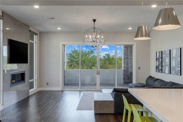 11280 Granite Ridge Dr Unit 1009, Las Vegas, NV 89135 - living area featuring dark wood-type flooring, a chandelier, baseboards, a tiled fireplace, and recessed lighting