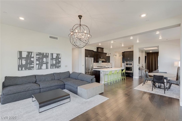 11280 Granite Ridge Dr Unit 1009, Las Vegas, NV 89135 - living area featuring a chandelier, dark wood-style flooring, and recessed lighting