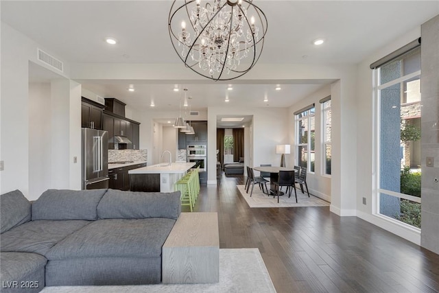 11280 Granite Ridge Dr Unit 1009, Las Vegas, NV 89135 - living area featuring dark wood-style flooring, baseboards, a chandelier, and recessed lighting