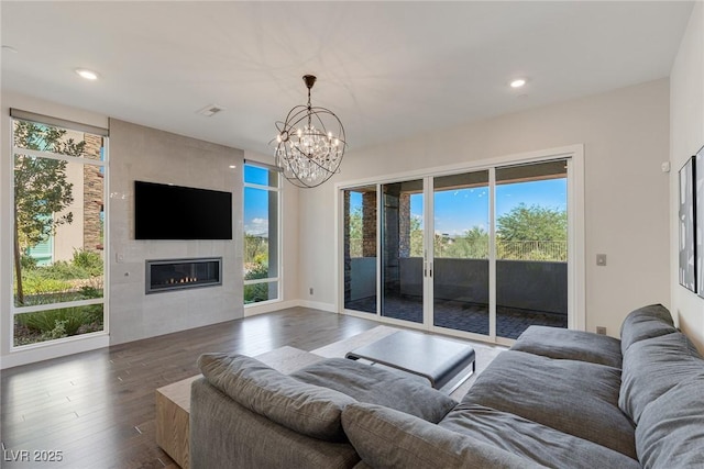 11280 Granite Ridge Dr Unit 1009, Las Vegas, NV 89135 - living room with a chandelier, wood finished floors, a tile fireplace, and recessed lighting