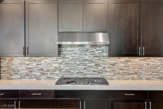 11280 Granite Ridge Dr Unit 1009, Las Vegas, NV 89135 - kitchen featuring under cabinet range hood, dark brown cabinetry, and light countertops