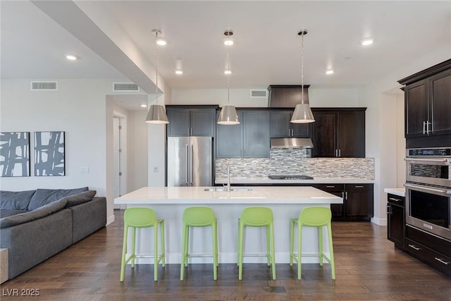11280 Granite Ridge Dr Unit 1009, Las Vegas, NV 89135 - kitchen featuring appliances with stainless steel finishes, a sink, open floor plan, decorative backsplash, and light countertops