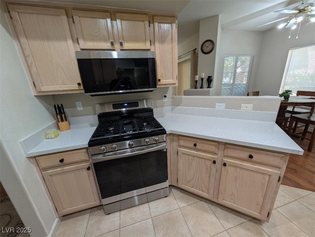 9000 Las Vegas Blvd Unit 1142, Las Vegas, NV 89123 - kitchen featuring stainless steel appliances, a peninsula, light brown cabinets, light countertops, and a ceiling fan