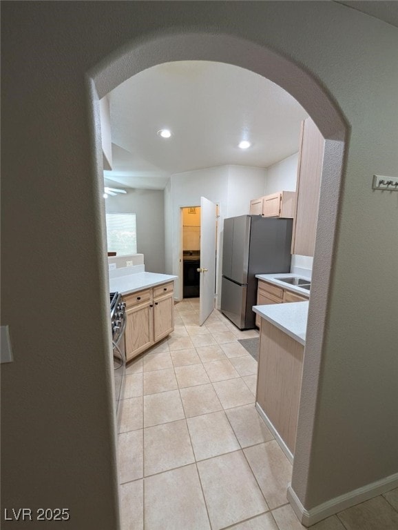 9000 Las Vegas Blvd Unit 1142, Las Vegas, NV 89123 - kitchen with appliances with stainless steel finishes, light brown cabinets, arched walkways, light countertops, and recessed lighting