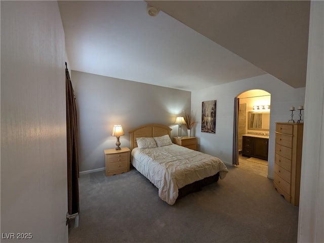 9000 Las Vegas Blvd Unit 1142, Las Vegas, NV 89123 - bedroom featuring light colored carpet, arched walkways, and ensuite bathroom