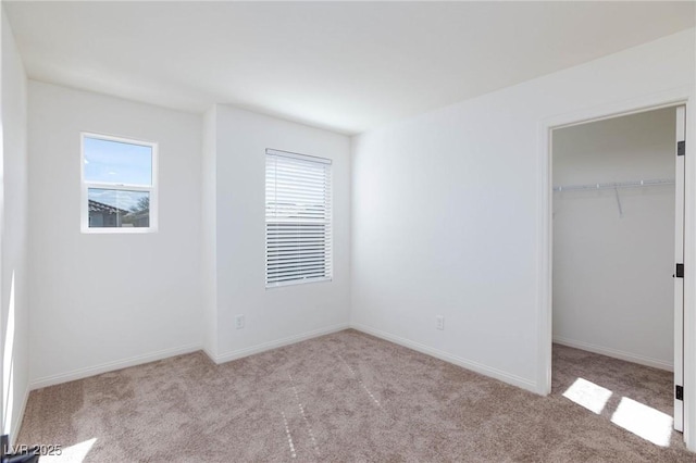 9086 Nostrand Ave, Las Vegas, NV 89148 - unfurnished bedroom featuring carpet floors, a walk in closet, a closet, and baseboards