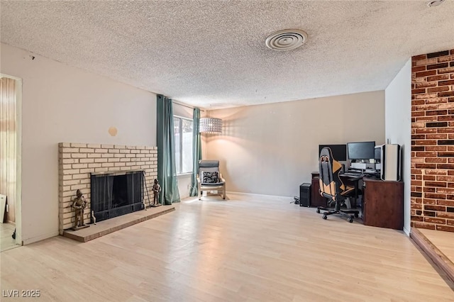 7898 Wishing Well Rd, Las Vegas, NV 89123 - office area with a textured ceiling, wood finished floors, and a fireplace