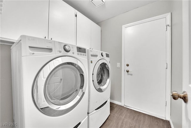2714 Bridgepointe Dr, Las Vegas, NV 89121 - laundry room with washing machine and dryer, wood finished floors, and cabinet space