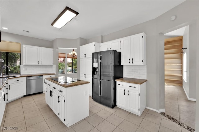 2714 Bridgepointe Dr, Las Vegas, NV 89121 - kitchen featuring dishwasher, fridge with ice dispenser, black electric cooktop, plenty of natural light, and recessed lighting