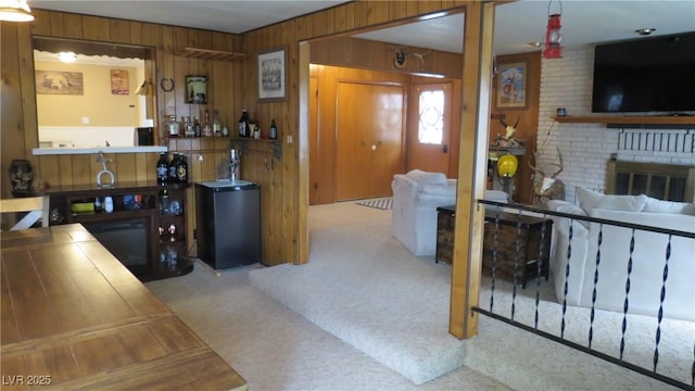 18 Connors Ct, Ely, NV 89301 - kitchen with a fireplace, carpet floors, wooden walls, and fridge