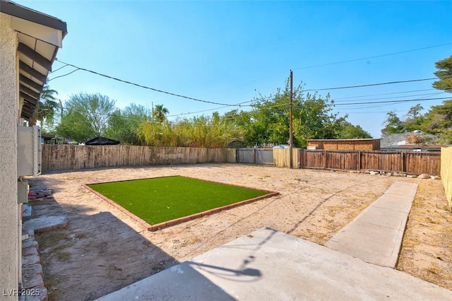 1411 Norman Ave, Las Vegas, NV 89104 - fenced backyard with a patio area