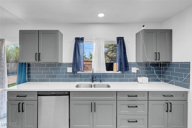 1411 Norman Ave, Las Vegas, NV 89104 - kitchen featuring stainless steel dishwasher, a sink, gray cabinets, tasteful backsplash, and recessed lighting