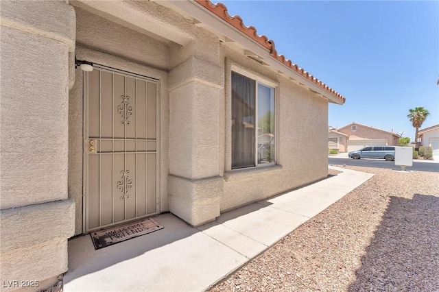 1011 Dancing Vines Ave, Las Vegas, NV 89183 - entrance to property featuring a tiled roof and stucco siding