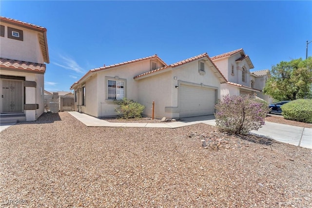 1011 Dancing Vines Ave, Las Vegas, NV 89183 - mediterranean / spanish house featuring a garage, stucco siding, a tile roof, and concrete driveway