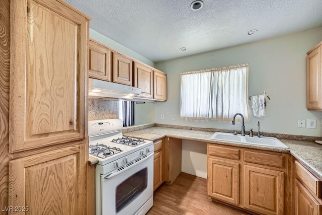 6766 Sebring St, Las Vegas, NV 89103 - kitchen featuring white gas range, under cabinet range hood, a textured ceiling, light countertops, and light wood-type flooring