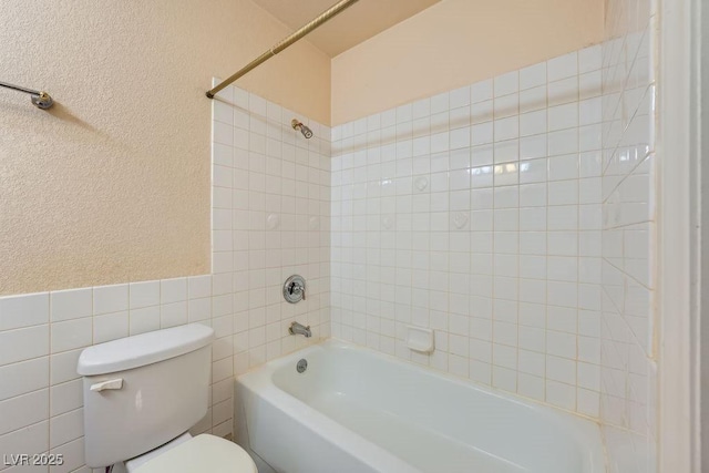6766 Sebring St, Las Vegas, NV 89103 - full bathroom with tile walls, shower / tub combination, and a textured wall