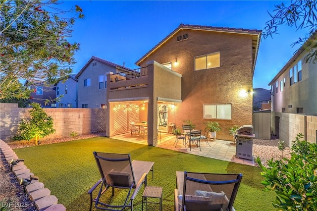 6546 American Flower St, Las Vegas, NV 89148 - back of property with a balcony, stucco siding, and a patio