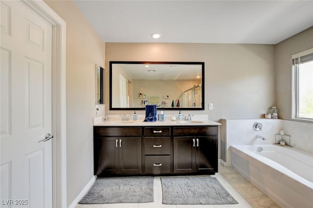 1425 Overseer Ave, Henderson, NV 89074 - full bath featuring double vanity, a garden tub, tile patterned floors, and baseboards