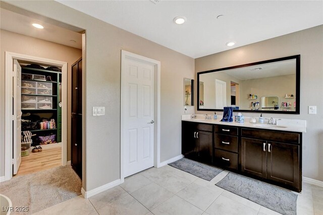 1425 Overseer Ave, Henderson, NV 89074 - bathroom with double vanity, baseboards, a walk in closet, recessed lighting, and tile patterned floors