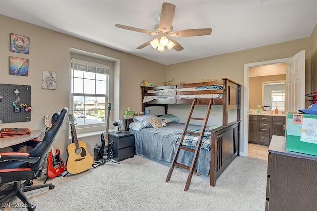 1425 Overseer Ave, Henderson, NV 89074 - bedroom featuring light carpet, ensuite bathroom, a desk, and a ceiling fan