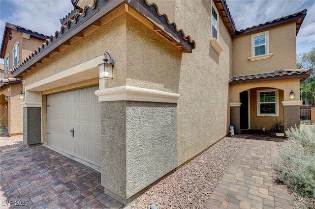1425 Overseer Ave, Henderson, NV 89074 - view of property exterior featuring stucco siding, a tile roof, and driveway