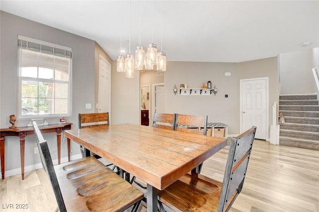 1425 Overseer Ave, Henderson, NV 89074 - dining area featuring stairway, light wood-style floors, a chandelier, and baseboards