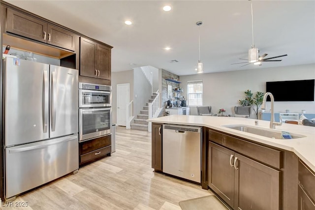 1425 Overseer Ave, Henderson, NV 89074 - kitchen featuring appliances with stainless steel finishes, a sink, light countertops, ceiling fan, and dark brown cabinets