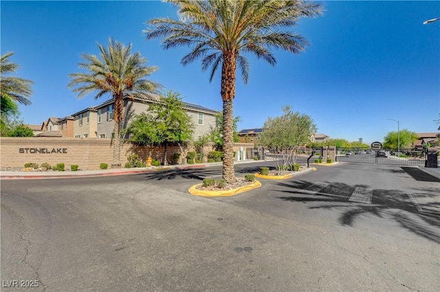 1425 Overseer Ave, Henderson, NV 89074 - view of asphalt street featuring street lights, a gate, a gated entry, and a residential view