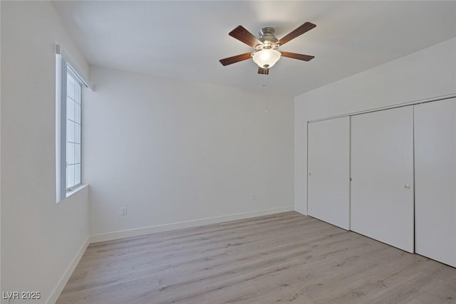 1830 N Buffalo Dr Unit 2024, Las Vegas, NV 89128 - unfurnished bedroom with multiple windows, light wood-style flooring, a closet, and baseboards