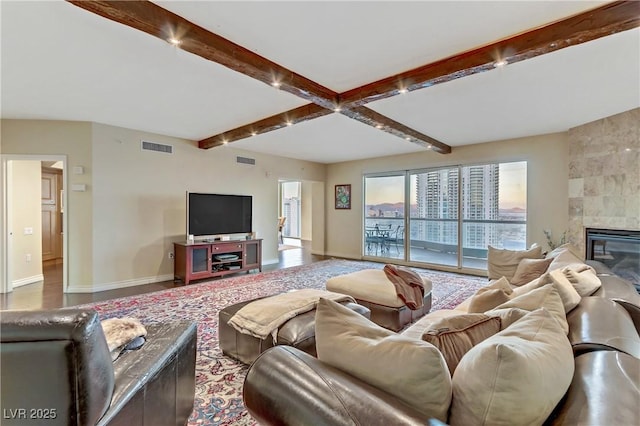 2777 Paradise Rd Unit 2001, Las Vegas, NV 89109 - living area featuring baseboards, beamed ceiling, and a tile fireplace