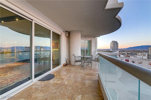 2777 Paradise Rd Unit 2001, Las Vegas, NV 89109 - balcony at dusk featuring a city view and a mountain view