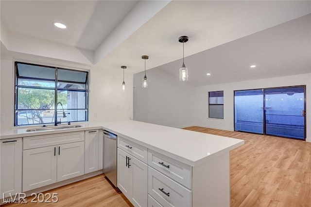 8412 Mulcahy Ave, Las Vegas, NV 89145 - kitchen with a sink, stainless steel dishwasher, a peninsula, light wood-style floors, and light countertops