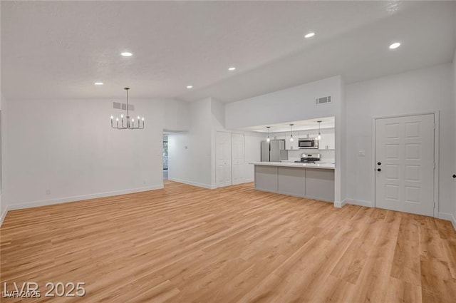 8412 Mulcahy Ave, Las Vegas, NV 89145 - unfurnished living room with a chandelier, vaulted ceiling, light wood-style floors, recessed lighting, and baseboards