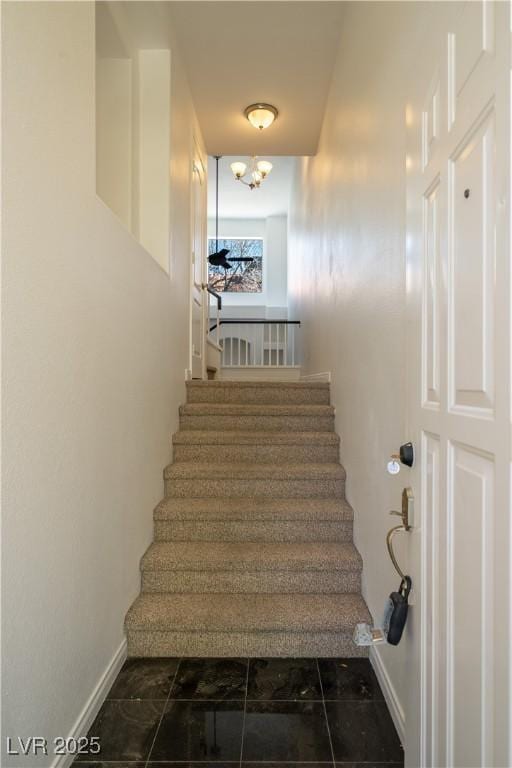 5256 Harvest Breeze Rd, Las Vegas, NV 89118 - stairs featuring baseboards and a chandelier