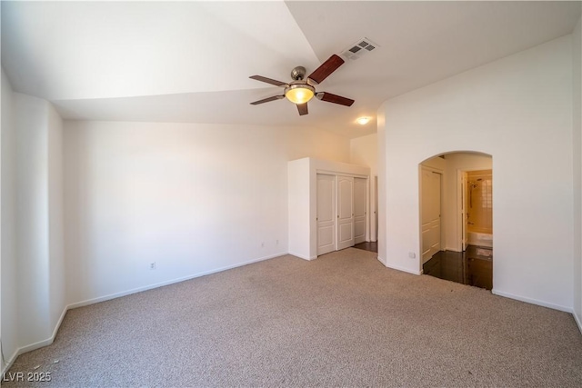 5256 Harvest Breeze Rd, Las Vegas, NV 89118 - unfurnished bedroom featuring arched walkways, carpet, lofted ceiling, and baseboards