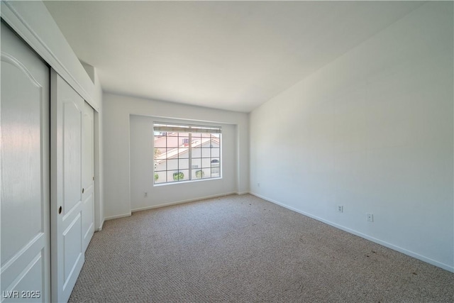 5256 Harvest Breeze Rd, Las Vegas, NV 89118 - unfurnished bedroom featuring light colored carpet, baseboards, and a closet