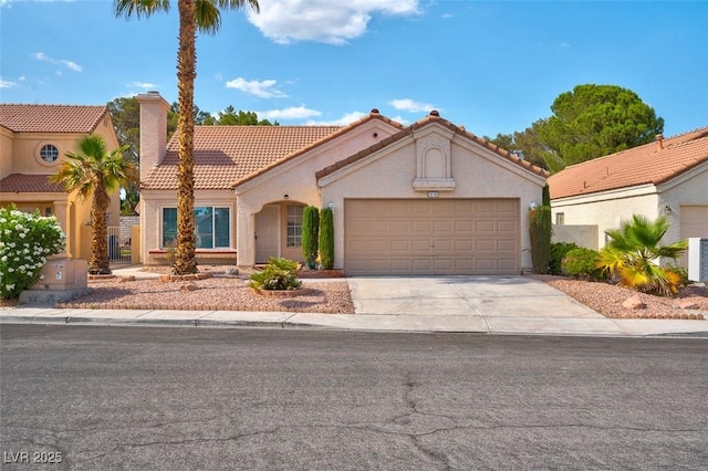 9116 Cypress Point Way, Las Vegas, NV 89117 - mediterranean / spanish home featuring a tile roof, an attached garage, driveway, stucco siding, and a chimney