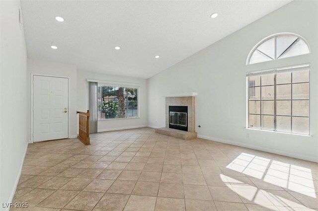 9116 Cypress Point Way, Las Vegas, NV 89117 - unfurnished living room featuring recessed lighting, a tiled fireplace, high vaulted ceiling, baseboards, and light tile patterned floors