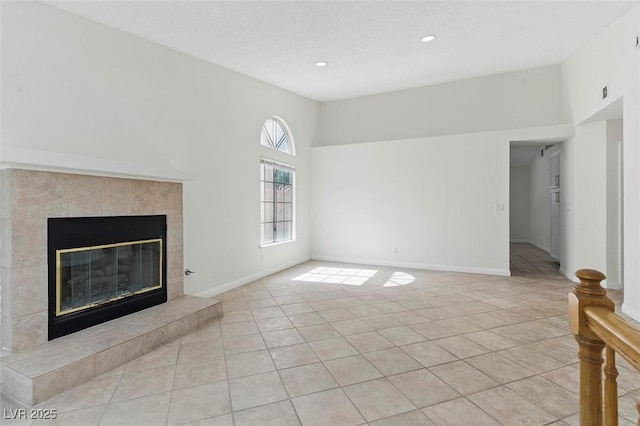 9116 Cypress Point Way, Las Vegas, NV 89117 - unfurnished living room featuring light tile patterned floors, a tile fireplace, recessed lighting, and baseboards